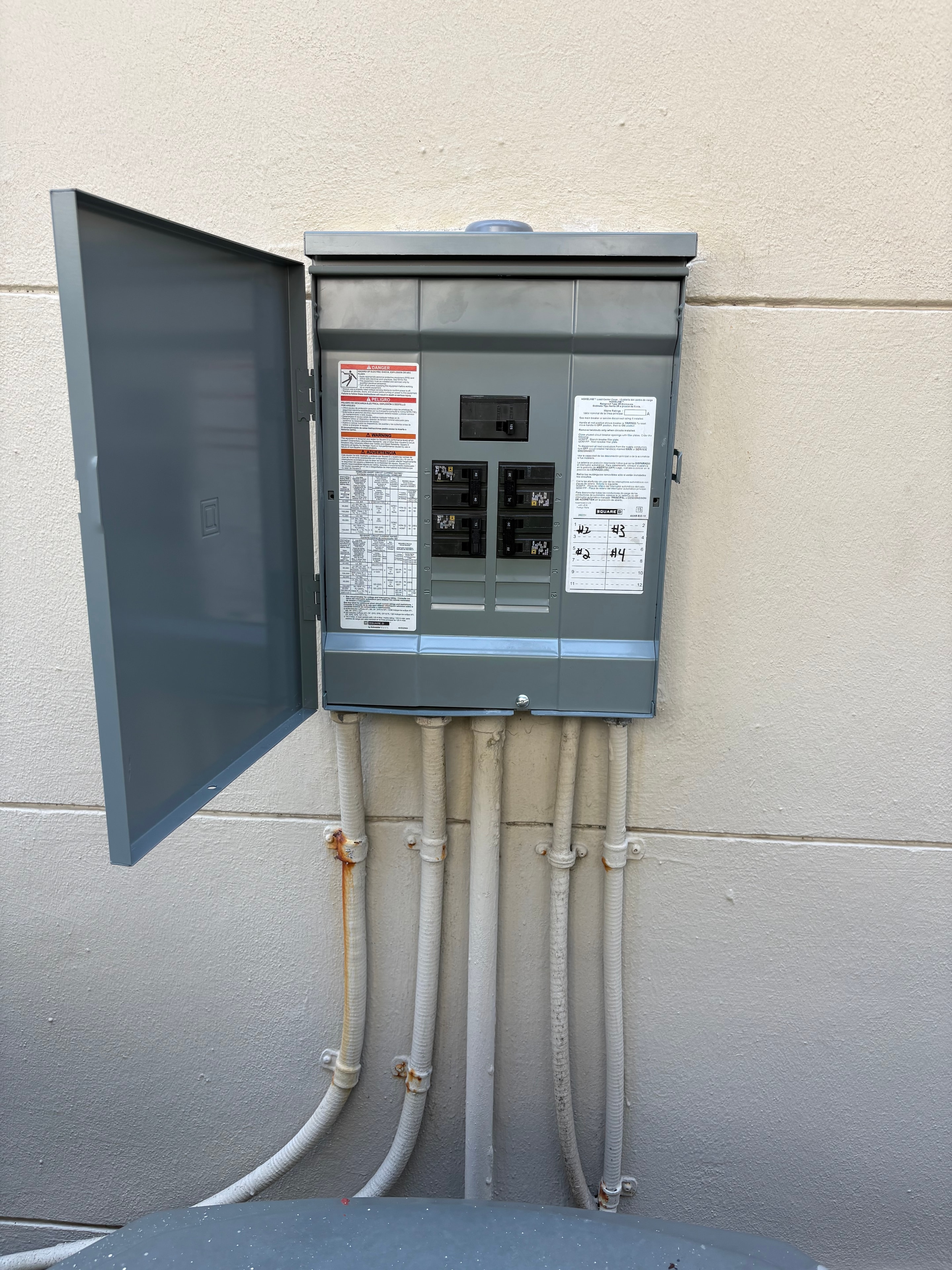 Outdoor subpanel with conduit runs — residential service upgrade